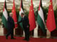 Chinese Premier Li Qiang, right, receives Palestinian President Mahmoud Abbas